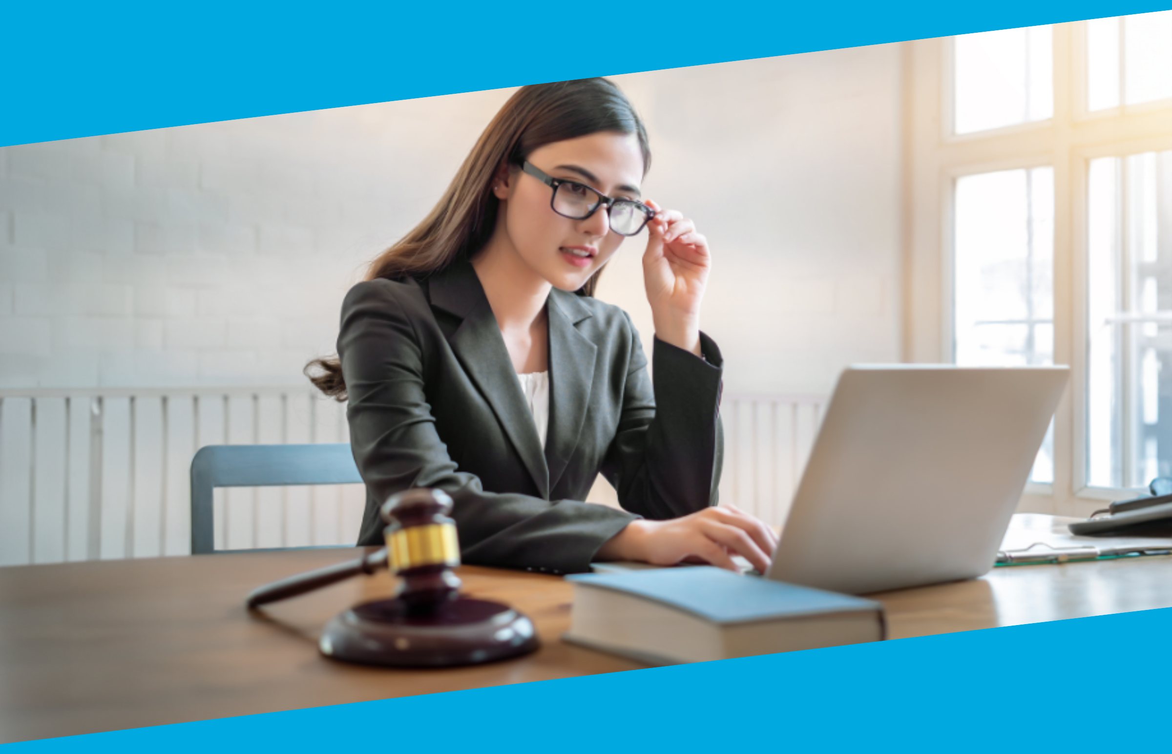 Woman sitting at desk with computer and gavel